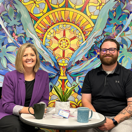 Two people having a conversation while sitting at a table.